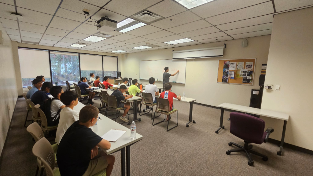 Wide view of students listening to debate lecture in 2026 camp classroom
