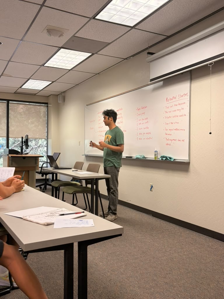 Instructor presenting rebuttal starters during 2026 debate session