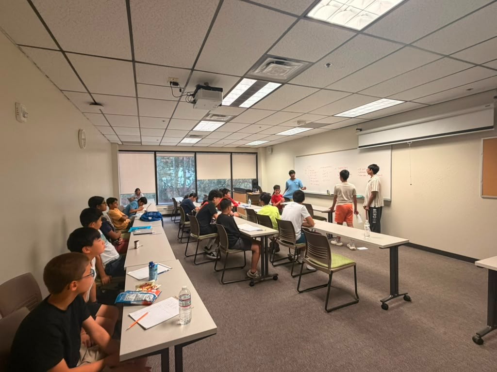 Students presenting speeches at the front of the classroom during 2026 camp